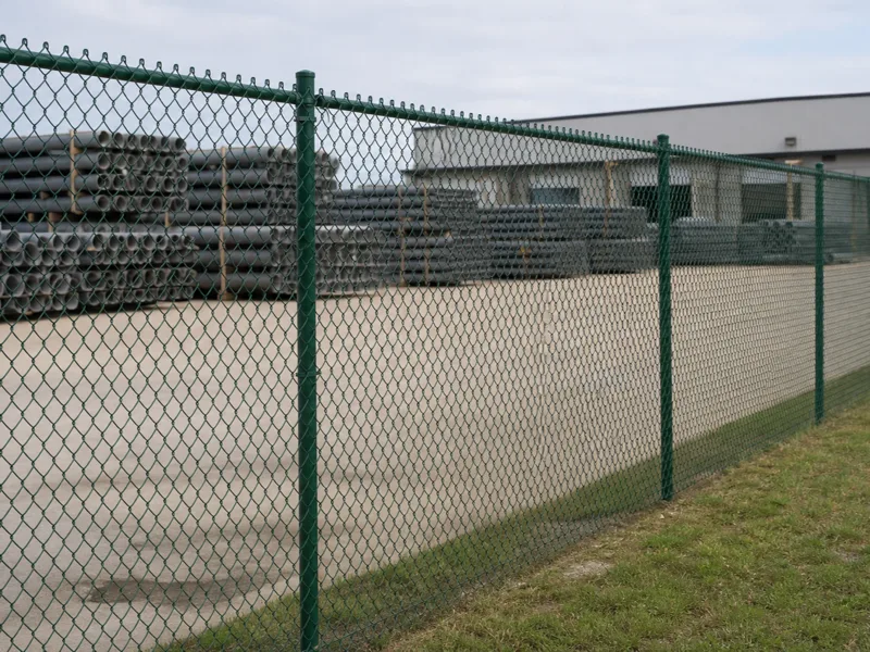 Green PVC coated chain link fence installation