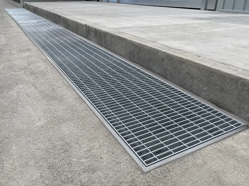 Stainless steel bar grating seated in a linear road drainage channel