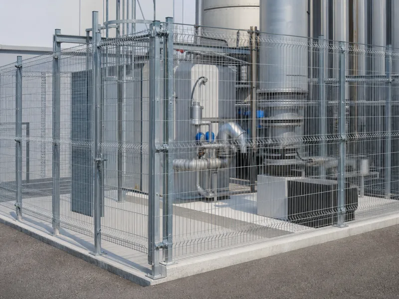 Galvanized welded wire mesh panel installation for an industrial enclosure